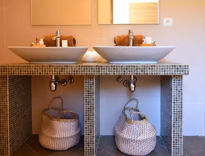 two sinks in a bathroom with two baskets at Valinco Locations OLMETO PLAGE in Olmeto