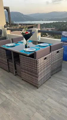 a table and chairs on a patio with a view at Villa Bella Vista in Porto-Vecchio