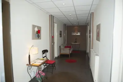 a hallway of a hospital with a table and chairs at Hotel du Palais in Ajaccio