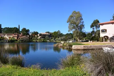 a view of a river with a building in the background at San Ciprianu in Porto-Vecchio