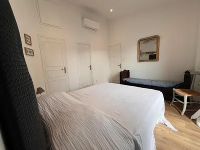 a bedroom with a white bed in a room at San Ciprianu in Porto-Vecchio
