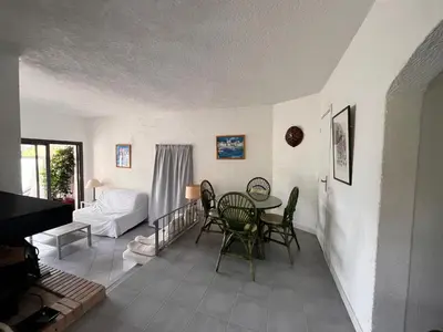 a living room with a table and chairs at San Ciprianu in Porto-Vecchio