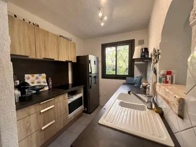 a kitchen with a sink and a refrigerator at San Ciprianu in Porto-Vecchio