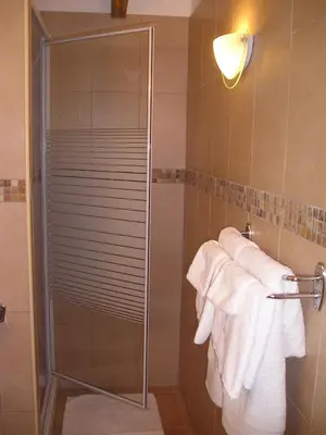 a shower with white towels in a bathroom at E Stelle di A Bella Vista in Bonifacio