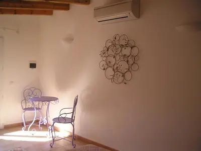 a table and two chairs in a room at E Stelle di A Bella Vista in Bonifacio