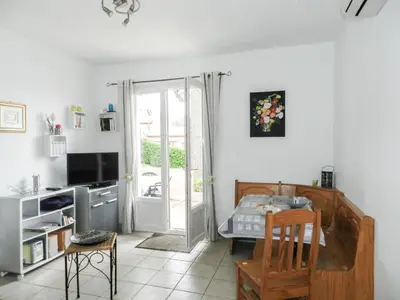 a kitchen with a table and a dining room at Holiday Home Cavoni by Interhome in Moriani Plage