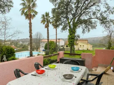 a table with bowls and plates on it on a patio at Holiday Home Cavoni by Interhome in Moriani Plage
