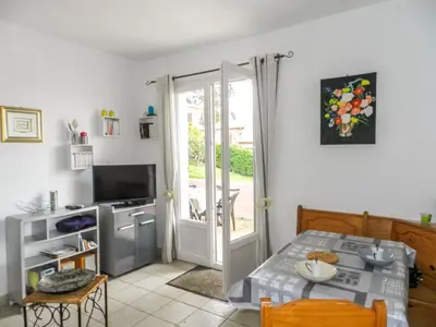 a kitchen with a table and a door to a patio at Holiday Home Cavoni by Interhome in Moriani Plage