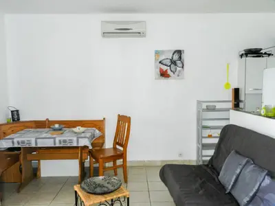 a living room with a table and a couch at Holiday Home Cavoni by Interhome in Moriani Plage
