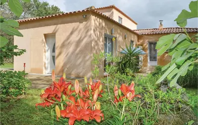 a house with red flowers in front of it at Nice Home In Ville Di Paraso With Wifi in Ville-di-Paraso