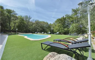 a yard with chairs and a swimming pool at Nice Home In Ville Di Paraso With Wifi in Ville-di-Paraso