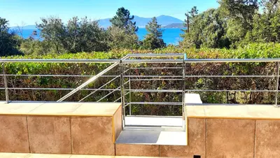 a set of stairs with a view of the ocean at Camélia Plein Soleil Bord de Plage in Coti-Chiavari