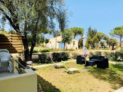 a living room with a couch and chairs and a table at Bungalows Filippi in Porto-Vecchio