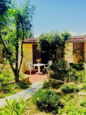 a kitchen with red cabinets and a white refrigerator at Bungalows Filippi in Porto-Vecchio