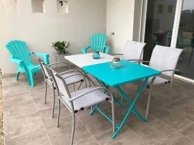 a blue table and chairs in a room at Villa Louise in Bonifacio