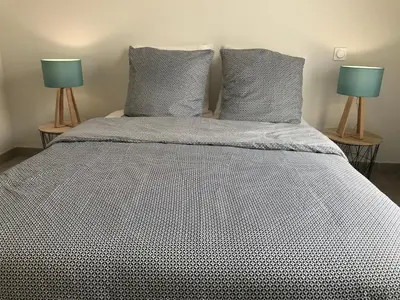 a bedroom with a bed with two lamps on it at Villa Louise in Bonifacio