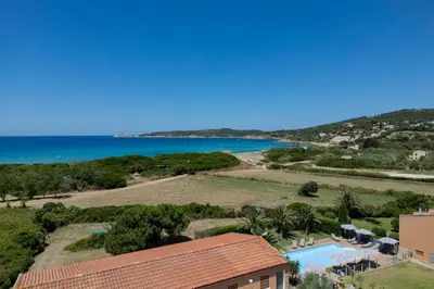 an aerial view of a resort with a pool and a beach at Hôtel Les Lentisques in Cargèse
