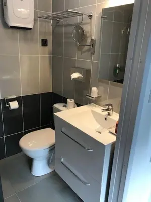a bathroom with a white toilet and a sink at Casa di a Restonica in Corte