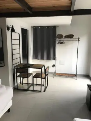 a room with a table and two chairs and a table and a ladder at Casa di a Restonica in Corte