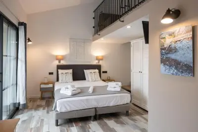 a bedroom with a large bed with towels on it at Casa di a Restonica in Corte
