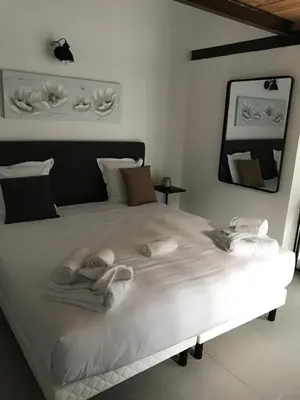 a bedroom with a white bed with towels on it at Casa di a Restonica in Corte