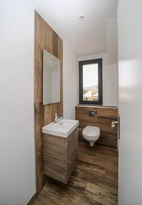 a bathroom with a sink and a toilet and a mirror at Hôtel confidentiel Le Grecale in Pianottoli-Caldarello