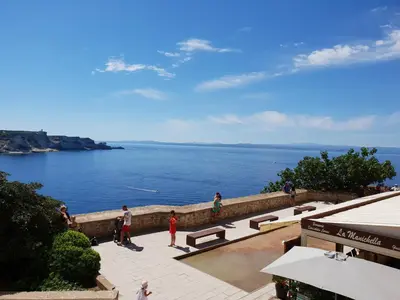 a group of people standing near the water at chez dume in Bonifacio