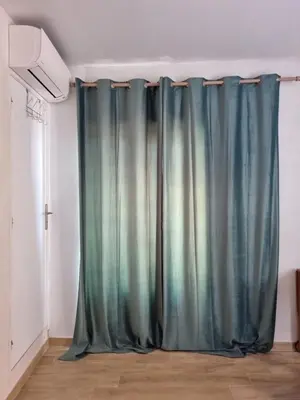 a curtain in the corner of a room at chez dume in Bonifacio