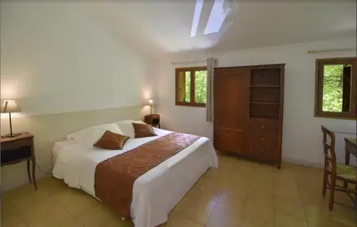 a bedroom with a bed and a table and chairs at Hotel Monte d'Oro in Vizzavona