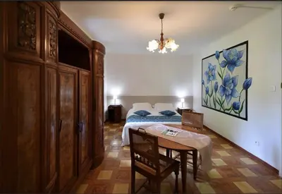 a bedroom with a bed and a table in it at Hotel Monte d'Oro in Vizzavona