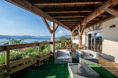 a porch with chairs and a view of the water at T2 vue sur le golfe d'Ajaccio in Porticcio