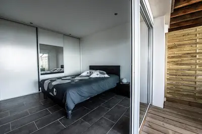 a bedroom with a bed and a mirror at T2 vue sur le golfe d'Ajaccio in Porticcio