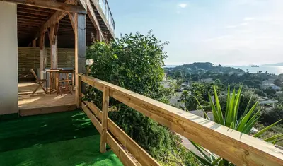 a wooden balcony of a house with a wooden fence at T2 vue sur le golfe d'Ajaccio in Porticcio