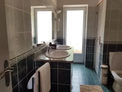 a bathroom with two sinks and a toilet at Chez Dume in Santa-Lucia-di-Tallano