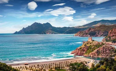 a view of a beach with mountains and the ocean at Résidence Le Porto in Porto Ota