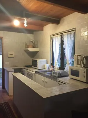 a kitchen with a counter top with a microwave at Petite maison proche de la nature in Vico