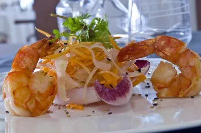 a plate of food with shrimp and vegetables on it at Radisson Blu Resort & Spa, Ajaccio Bay in Porticcio
