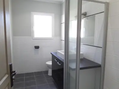 a bathroom with a sink and a toilet at Villa piscine vue mer in Pietrosella