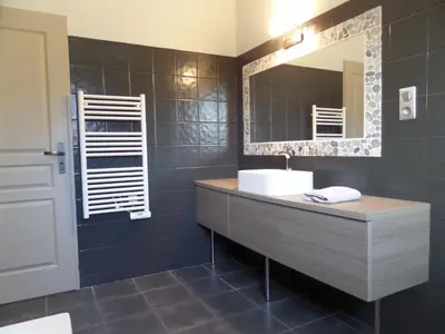 a bathroom with a sink and a mirror at Villa piscine vue mer in Pietrosella