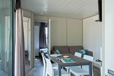 a dining room and living room with a table and chairs at Casa e Natura in Moriani Plage