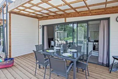 a patio with a table and chairs on a deck at Casa e Natura in Moriani Plage