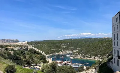 a cruise ship docked in a harbor at Le Royal Hôtel Restaurant in Bonifacio