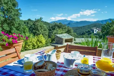 a table with a table cloth with food on it at A Ghjuvellina in Piedigriggio
