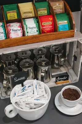 a counter with a bowl of coffee and a shelf with books at Le Vaita in Porto Ota