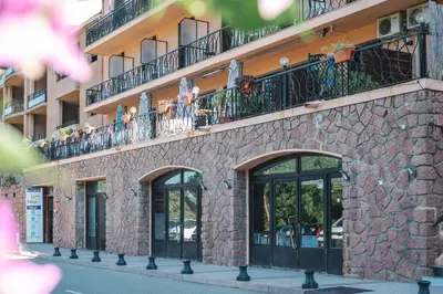 a building with people on the balconies of it at Le Vaita in Porto Ota