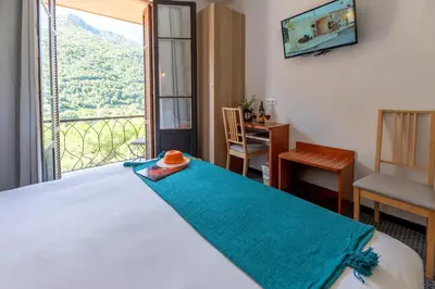 a bedroom with a bed and a large window at Le Vaita in Porto Ota