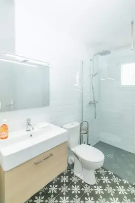 a bathroom with a sink and a toilet and a shower at Dans mon jardin in Ajaccio