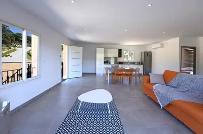 a living room with a couch and a table at Sarl Valinco Locations in Olmeto