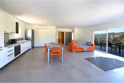 a kitchen and living room with a table and chairs at Sarl Valinco Locations in Olmeto