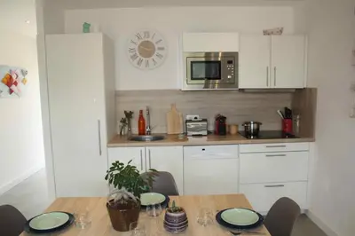 a kitchen with a table and a microwave at Résidence U Rapalinu in Molini